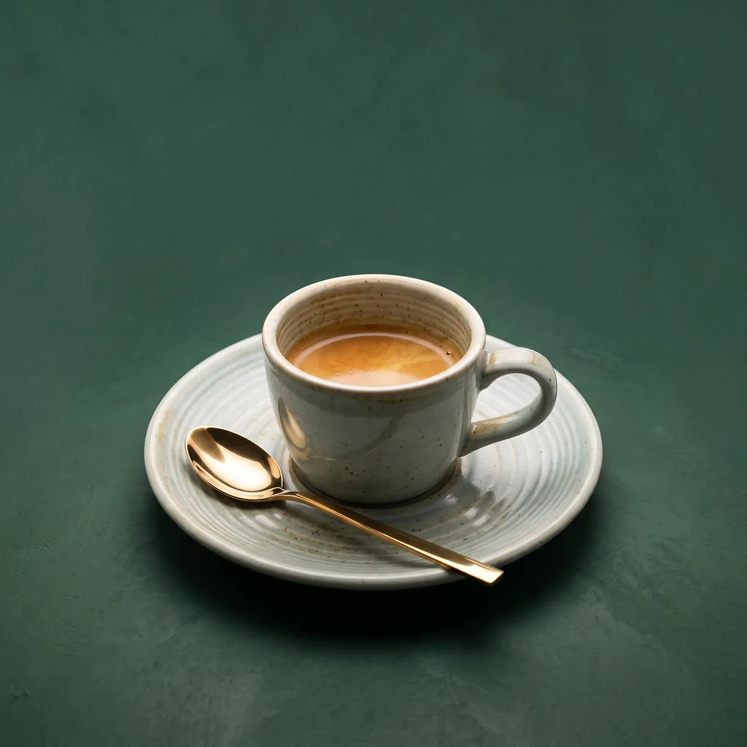 Espresso Italiano served short in a ceramic cup and saucer