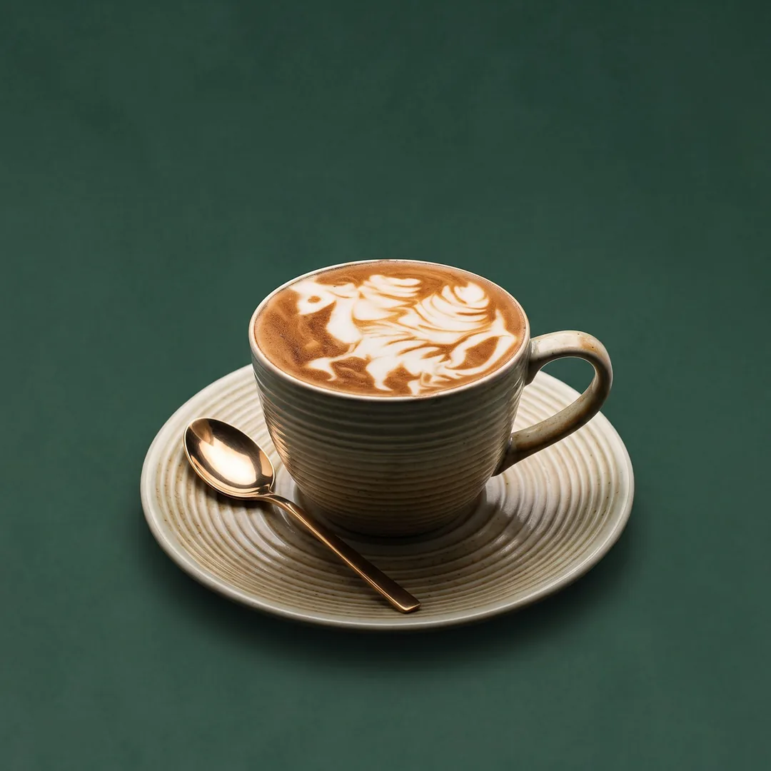 Cappuccino with rosetta latte art in a stoneware cup