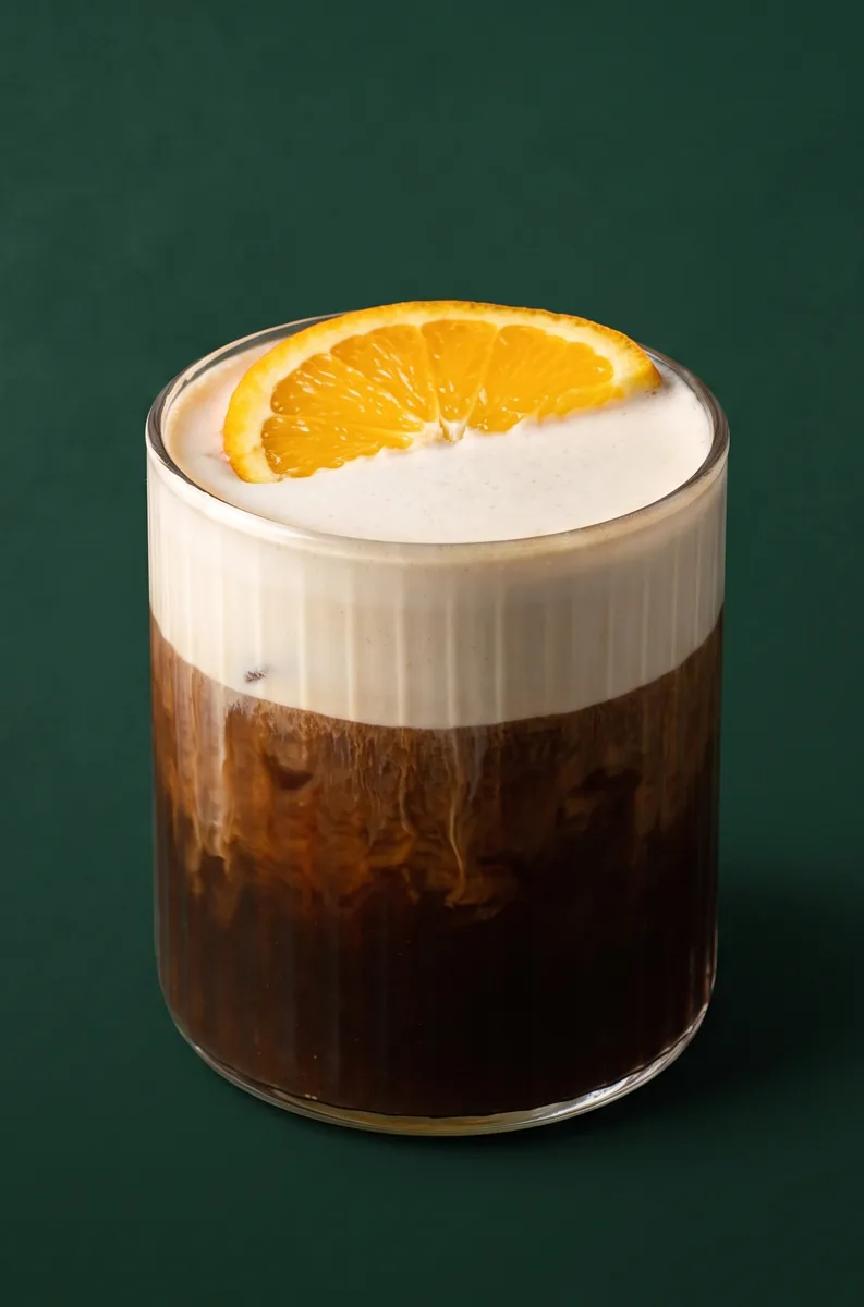 Mont Blanc cold brew with orange cream foam and an orange wheel