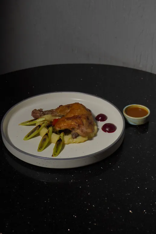 Confit chicken with charred baby corn and a jug of jus