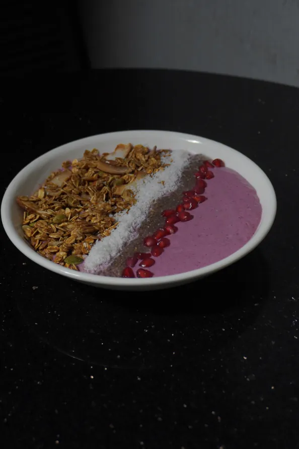 Mixed berry smoothie bowl with granola and pomegranate