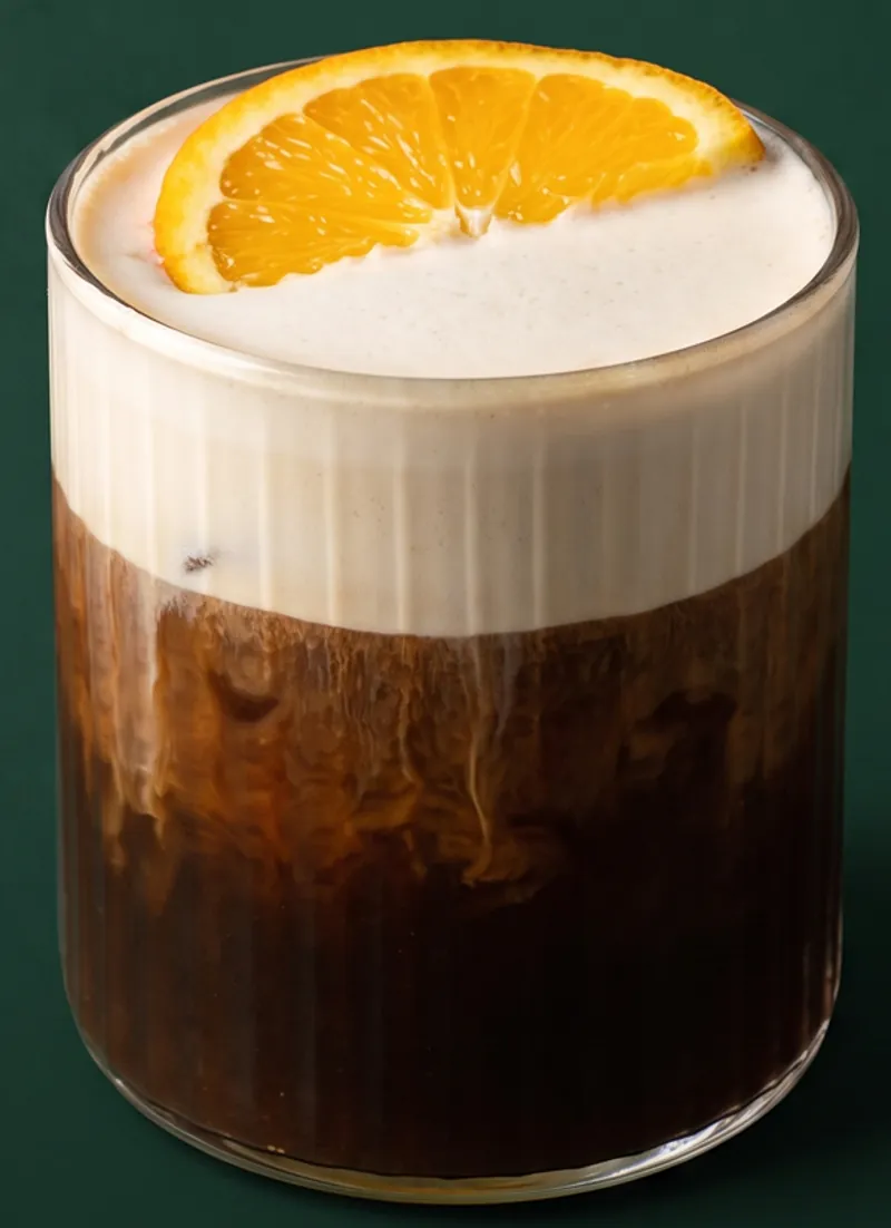Mont Blanc cold brew with orange cream foam and an orange wheel